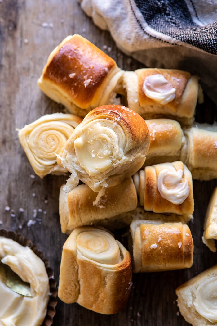 overhead close up photo of Salted Honey Butter Parker House Roll with butter on roll