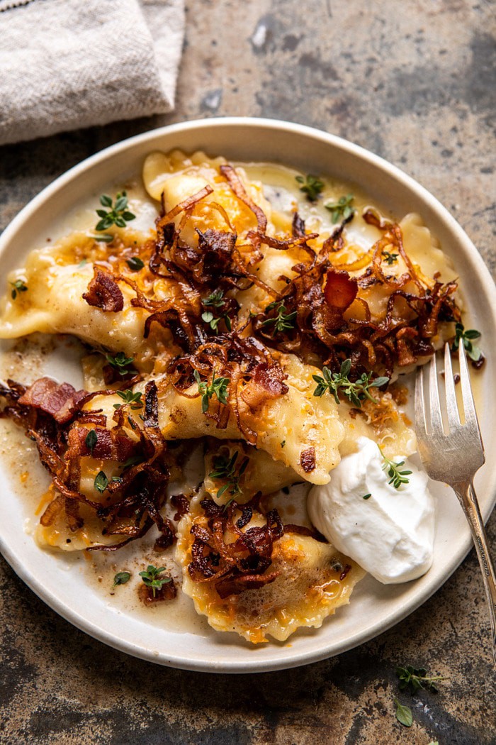 overhead close up photo Cheddar Pierogies with Caramelized Onions and Bacon