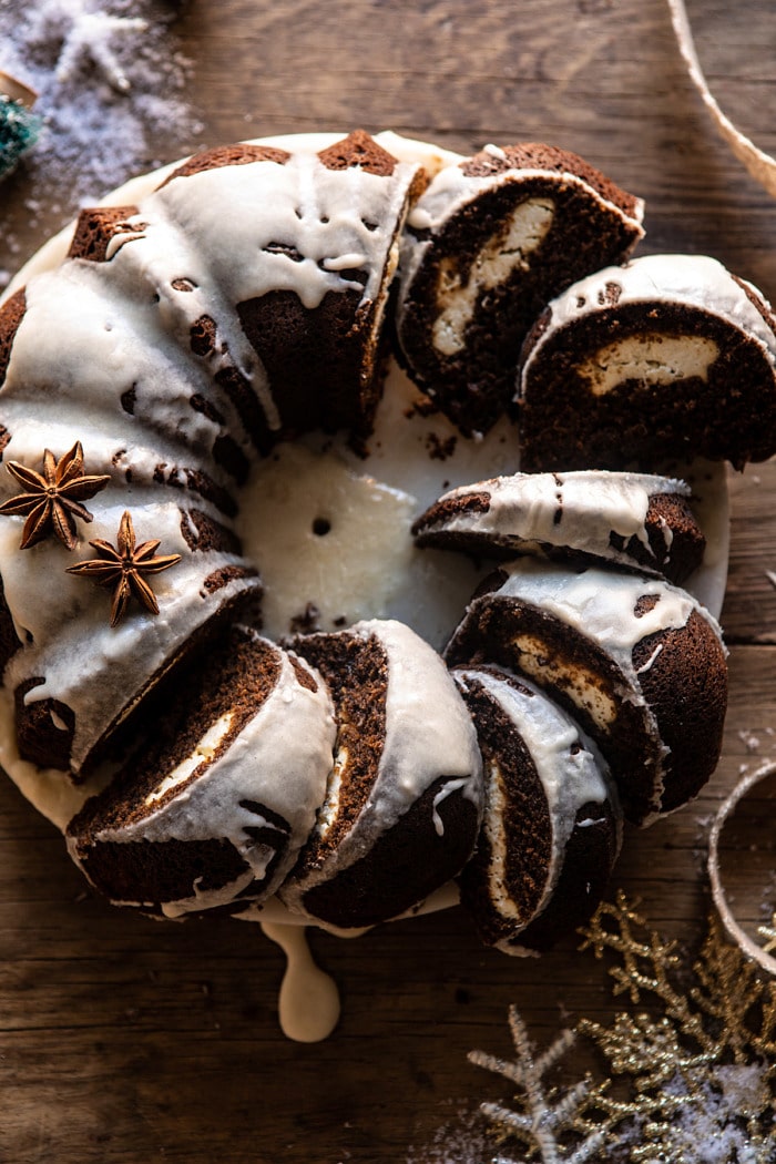 overhead close up photo of Cream Cheese Swirled Chai Gingerbread Cake with multiple slices of cake cut