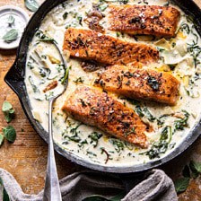 Creamy Spinach and Artichoke Salmon | halfbakedharvest.com #salmon #garlicbutter #easyrecipes