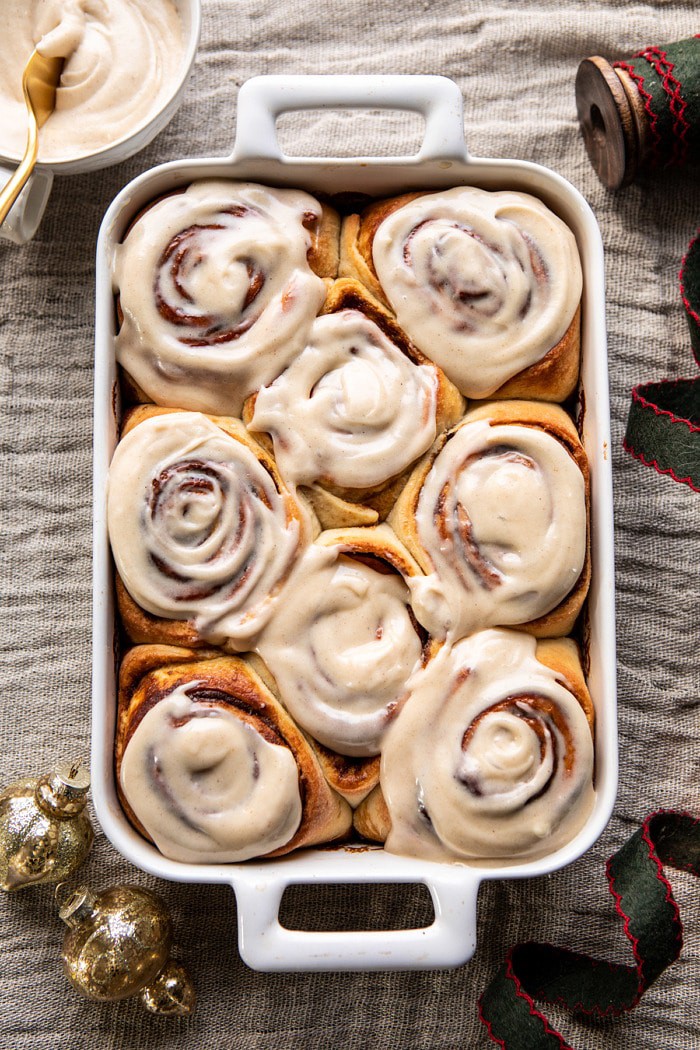 overhead photo of Easy Gingerbread Brioche Cinnamon Rolls with frosting on rolls 