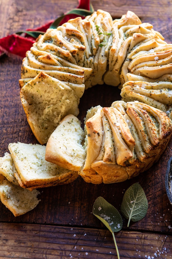 side angled photo of Pull-Apart Garlic Butter Bread Wreath with a few slices pulled away from bread
