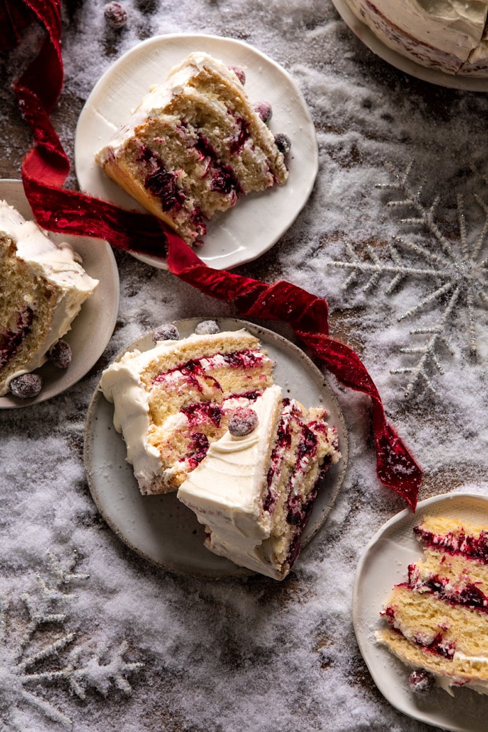 overhead photo of White Christmas Cranberry Layer Cake slices on dessert plates