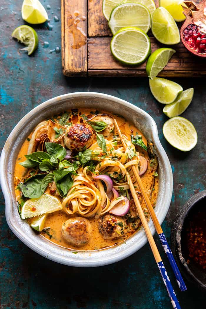 overhead close up photo of 30 Minute Thai Chicken Meatball Khao Soi with chopsticks in soup bowl 