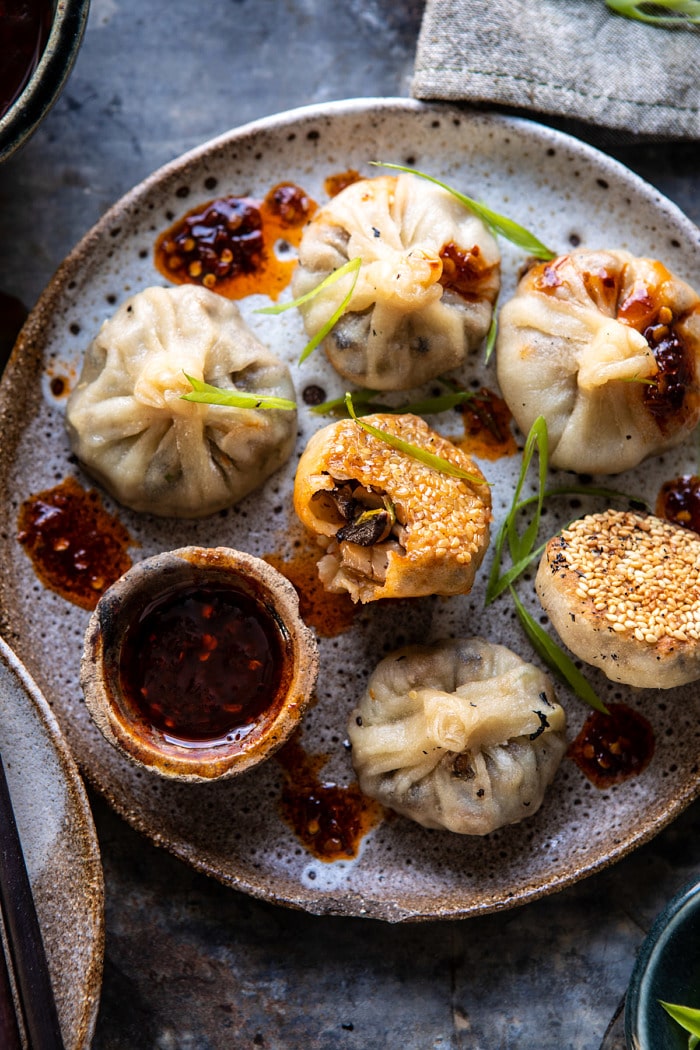 overhead photo of Chinese Mushroom Dumplings with Sweet Chili Ginger Sesame Sauce and bite taken out of dumpling