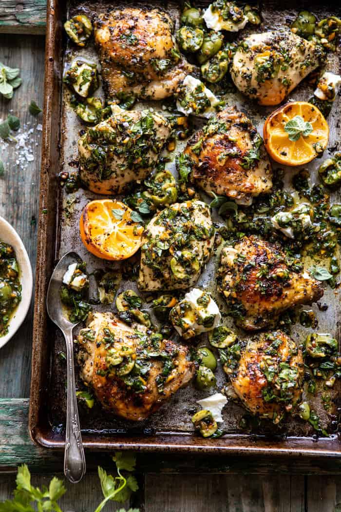 overhead photo of Roasted Garlic Butter Chicken with Lemon Olive Dressing on sheet pan with spoon on pan