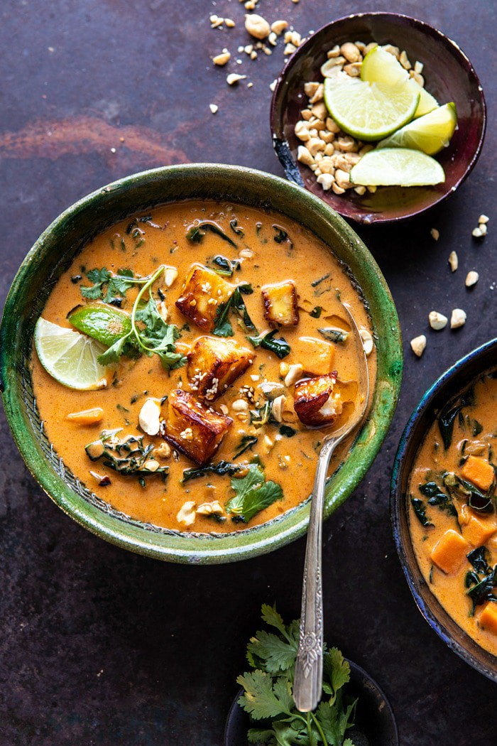 overhead photo of Spicy Peanut Soup with Sesame Halloumi with spoon in bowl