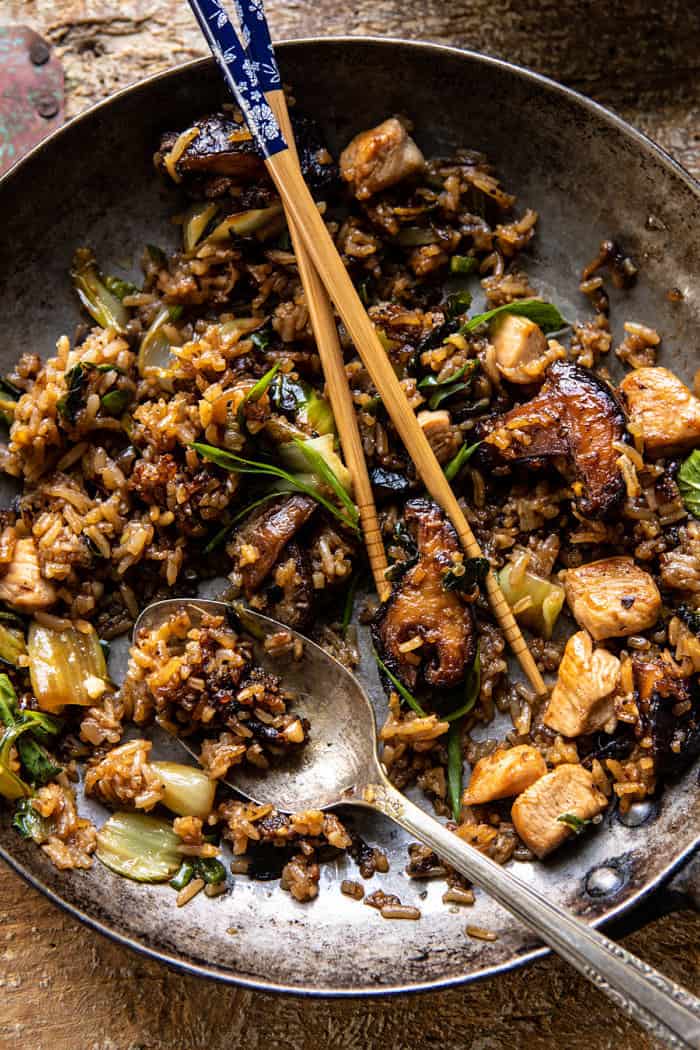 overhead photo of Better Than Takeout Sesame Ginger Chicken Fried Rice with chopsticks in skillet to show the food has been eaten