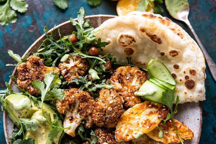 overhead close up horizontal photo of Cauliflower Shawarma with Green Tahini and Fried Halloumi