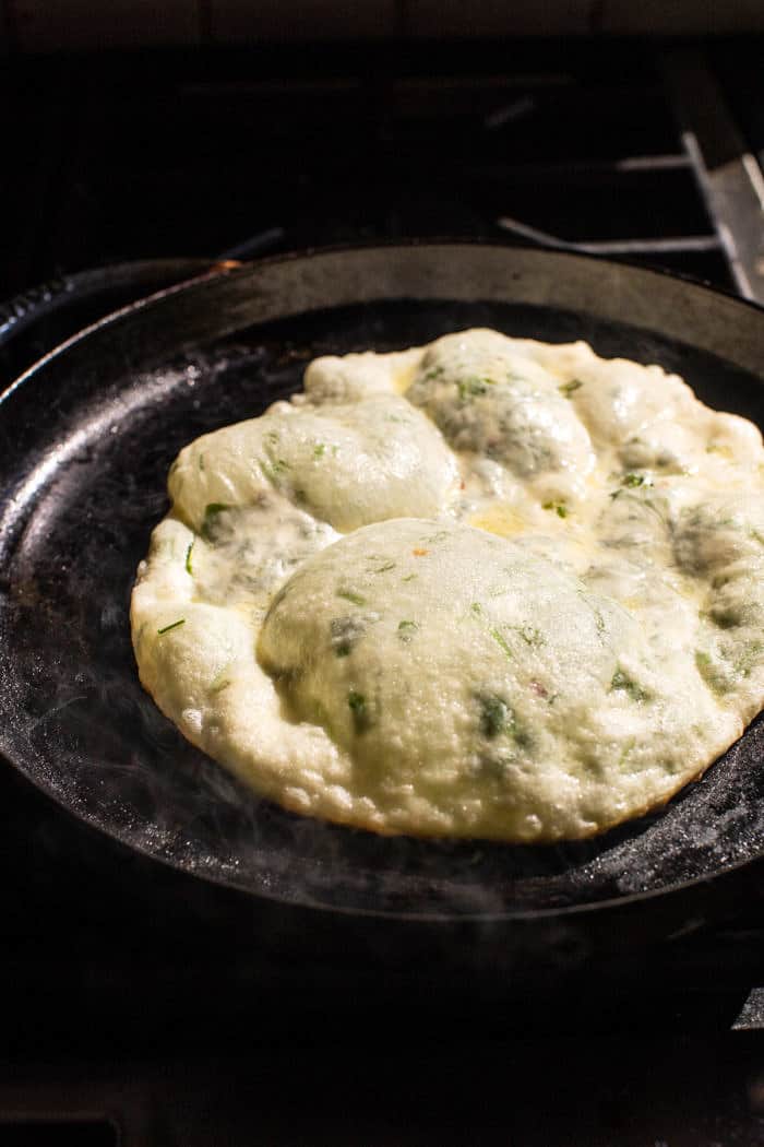 prep photo of Cheesy Herb Stuffed Naan cooking on skillet