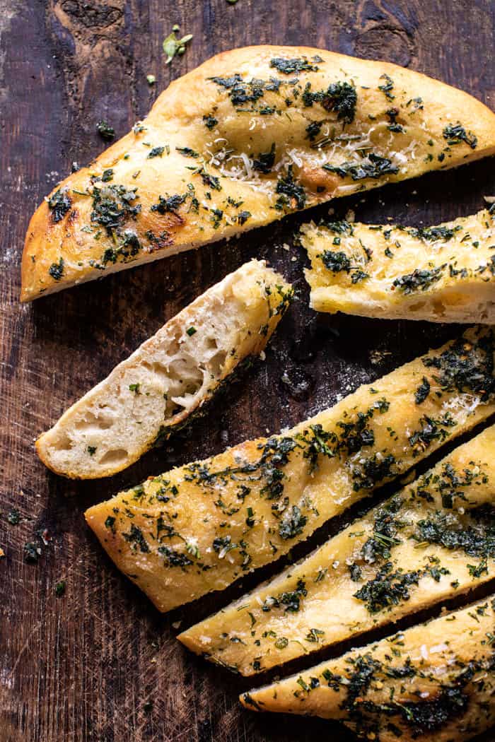 overhead close up photo of No Knead Rosemary Garlic Parmesan Bread with bread slices cut