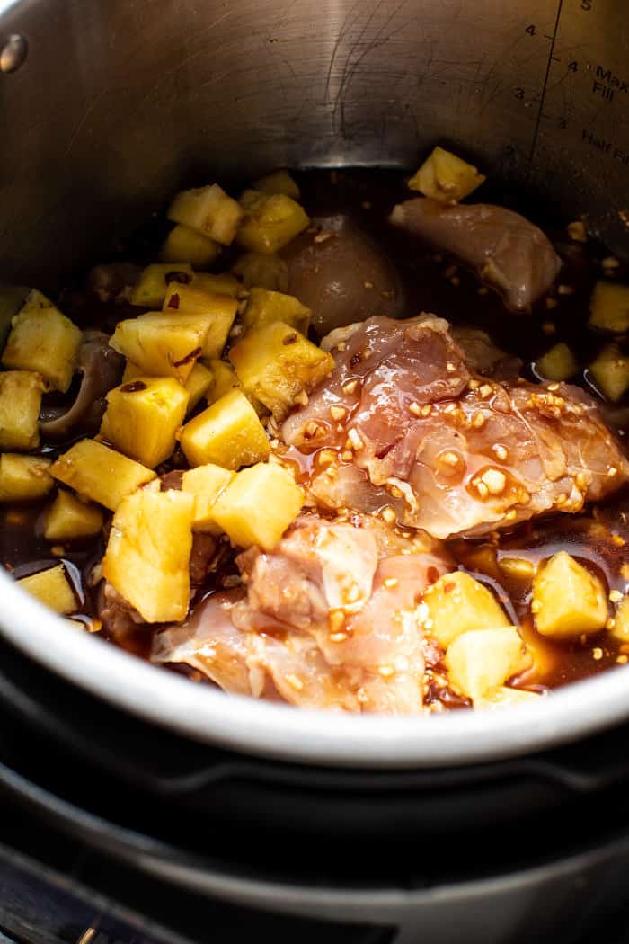 prep photo of pineapple and chicken in slow cooker before cooking