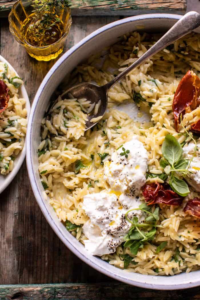 overhead photo fo 20 Minute Orzo Carbonara with Crispy Prosciutto and Burrata with serving spoon in bowl 