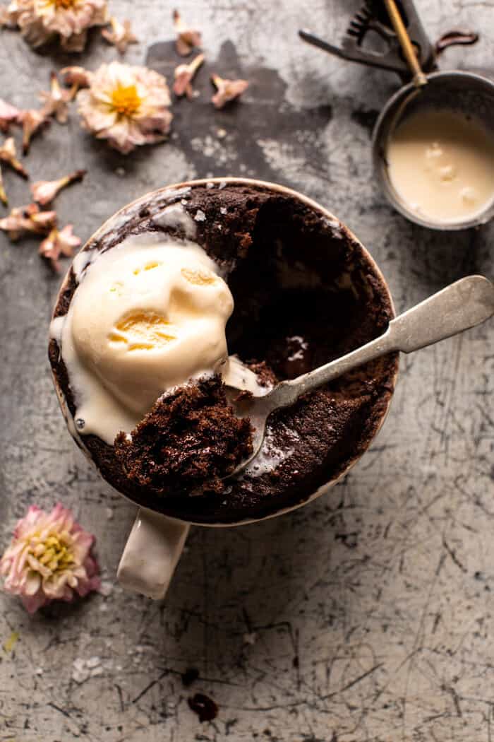 overhead photo of 5 Minute Molten Chocolate Mug Cake with spoon showing the inside of the cake