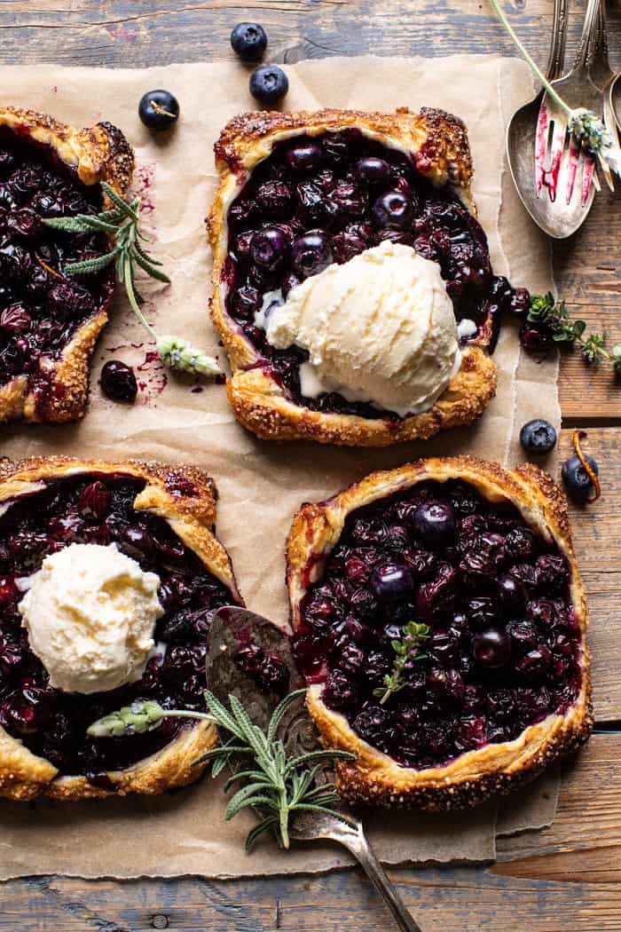 overhead photo of Bursting Blueberry Lemon Thyme Tarts with ice cream on top