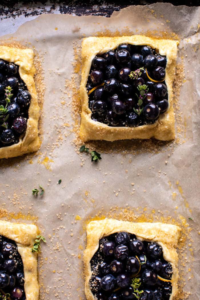 overhead prep photo of Bursting Blueberry Lemon Thyme Tarts on baking sheet before baking 