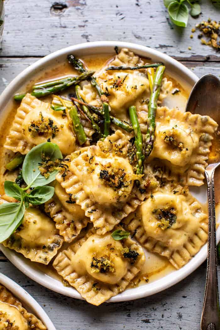 overhead close up photo of Lemon Butter Cheese Ravioli with Garlic Basil Breadcrumbs on plate with spoon