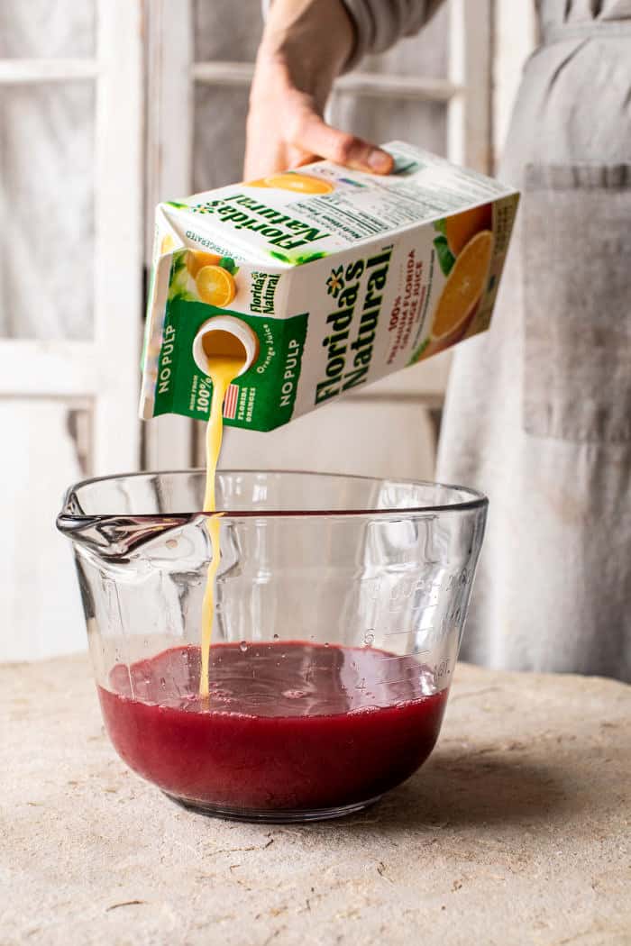 side angled photo of pouring orange juice