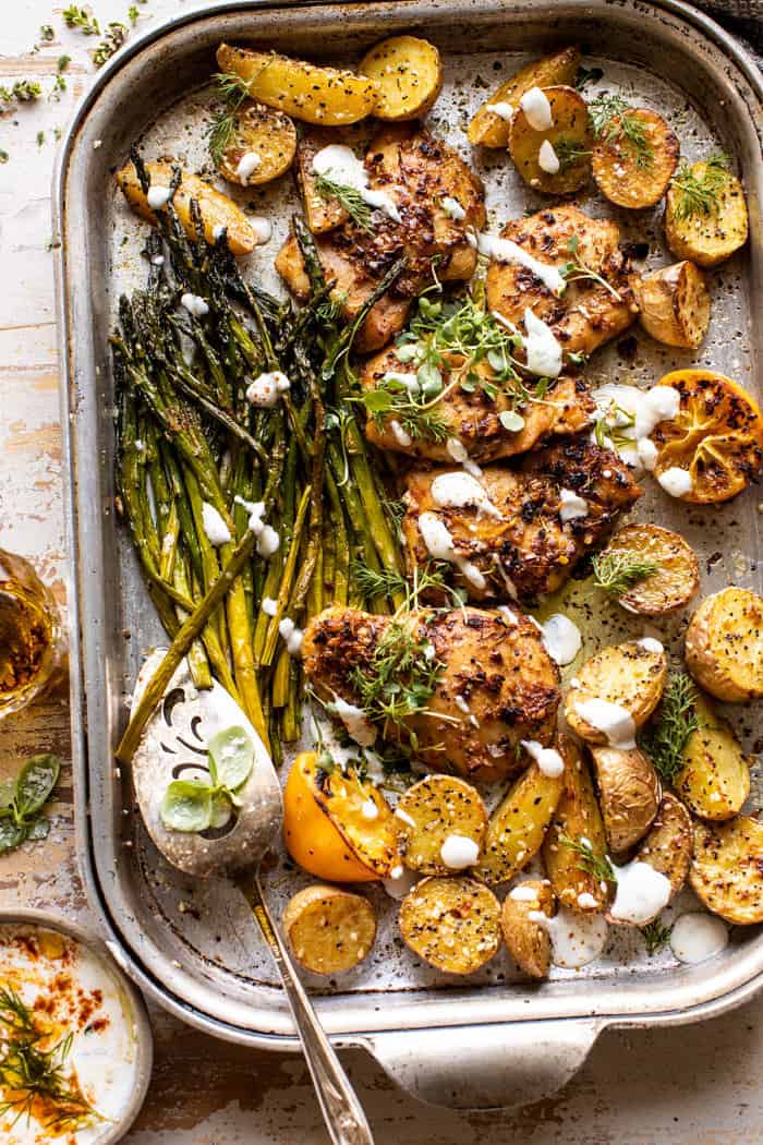 overhead photo of Sheet Pan Lemon Rosemary Dijon Chicken and Potatoes with Feta Goddess Sauce 