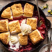 Skillet Strawberry Bourbon Cobbler with Layered Cream Cheese Biscuits.