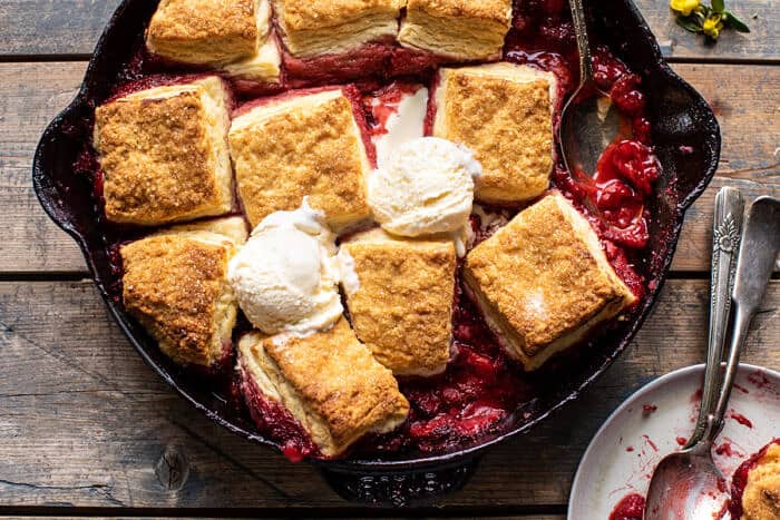 overhead horizontal photo of Skillet Strawberry Bourbon Cobbler with Layered Cream Cheese Biscuits 