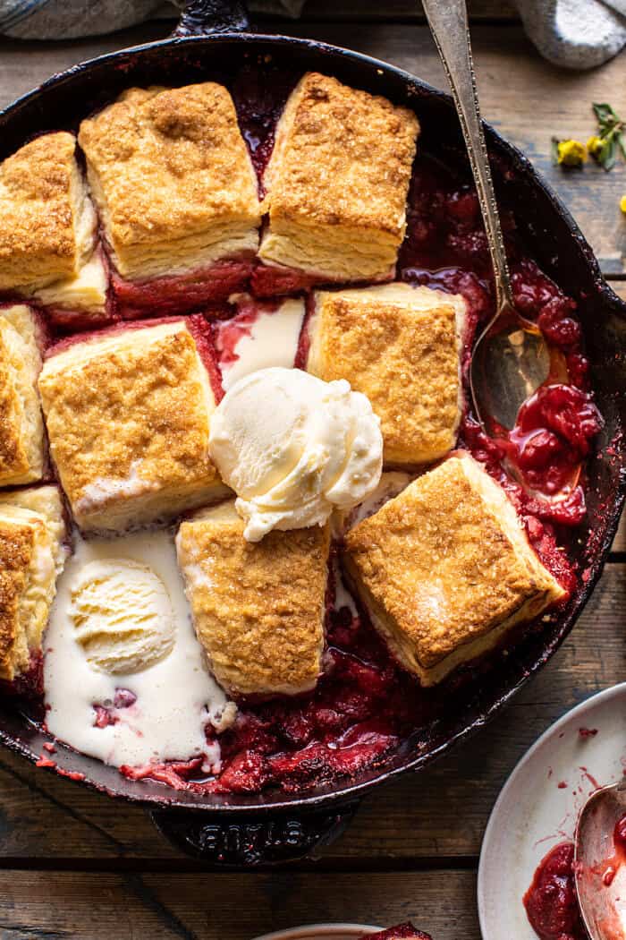 overhead close up photo of Skillet Strawberry Bourbon Cobbler with Layered Cream Cheese Biscuits 