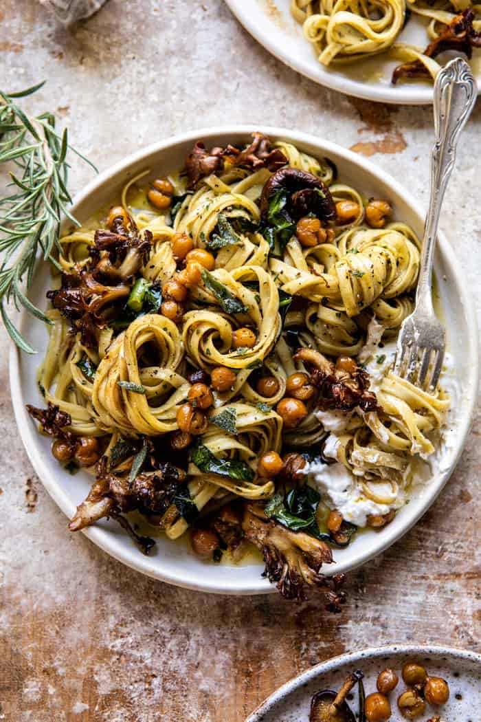 overhead photo of Slow Roasted Mushroom Pasta with Crisp Rosemary Chickpeas with fork twirling pasta on plate