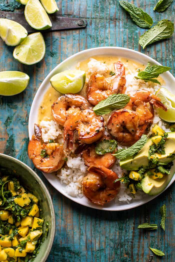 overhead photo of 20 Minute Honey Garlic Butter Shrimp on plate with rice and mangos 