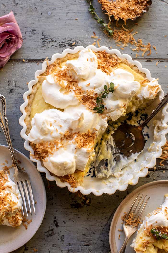 overhead photo of Lemon Sugar Coconut Cream Pie with 2 slices of pie cut and removed from pie