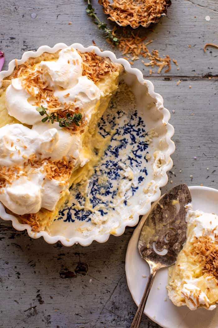 overhead photo of Lemon Sugar Coconut Cream Pie with half the pie cut into slices 