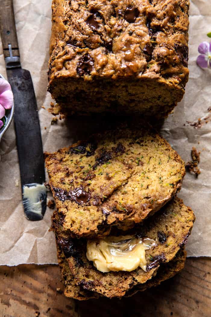 overhead photo of Chocolate Chunk Almond Butter Zucchini Bread with 3 slices of bread cut