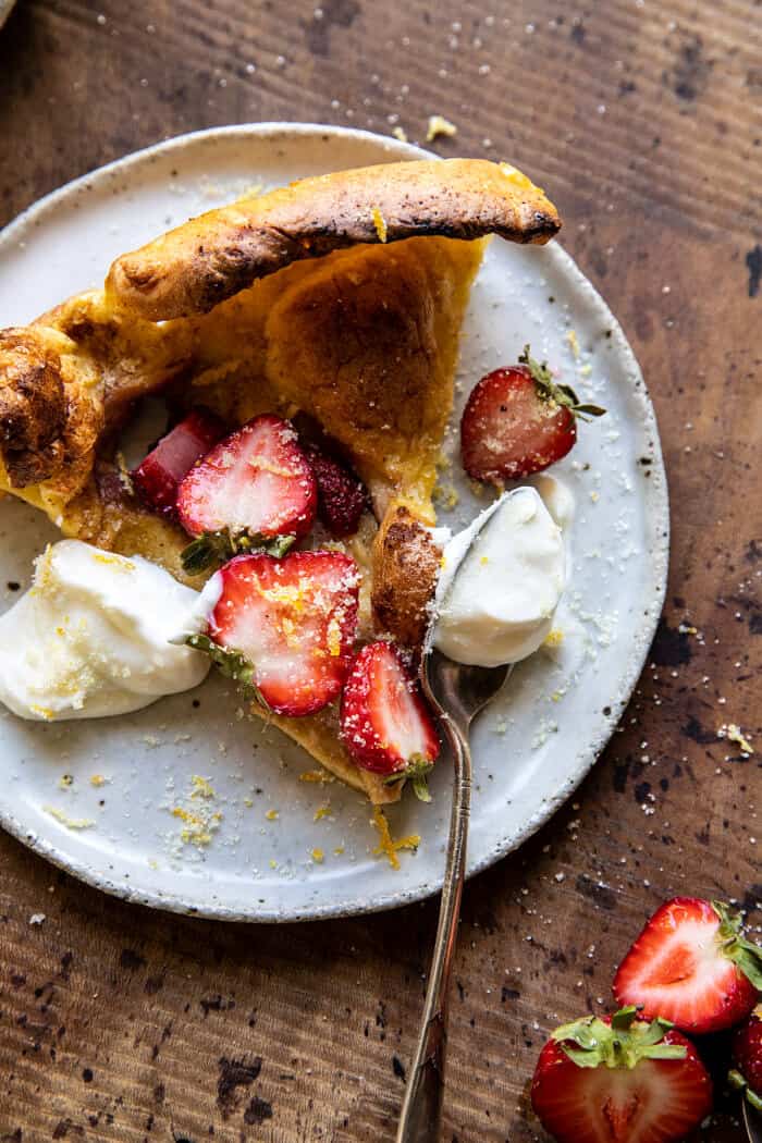 overhead photo of Lemon Strawberry Dutch Baby with Ricotta Cream on serving plate