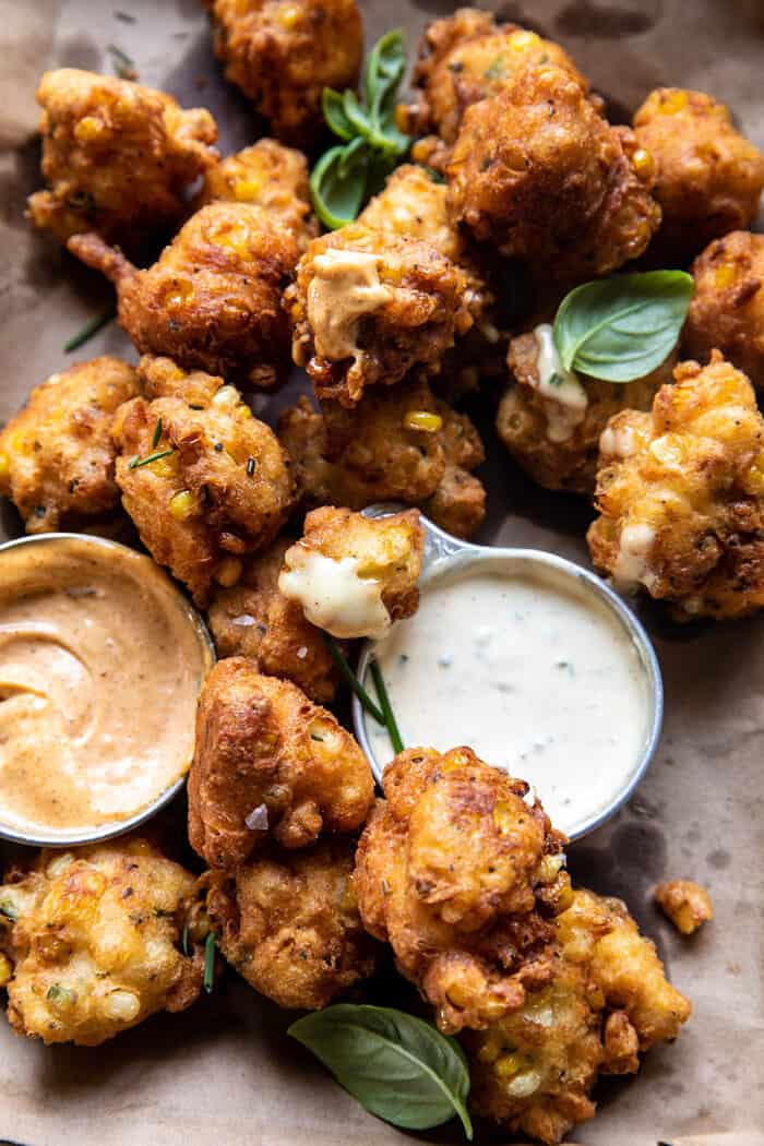 side angled close up photo of Jalapeño Cheddar Corn Fritters with Chipotle Aioli 