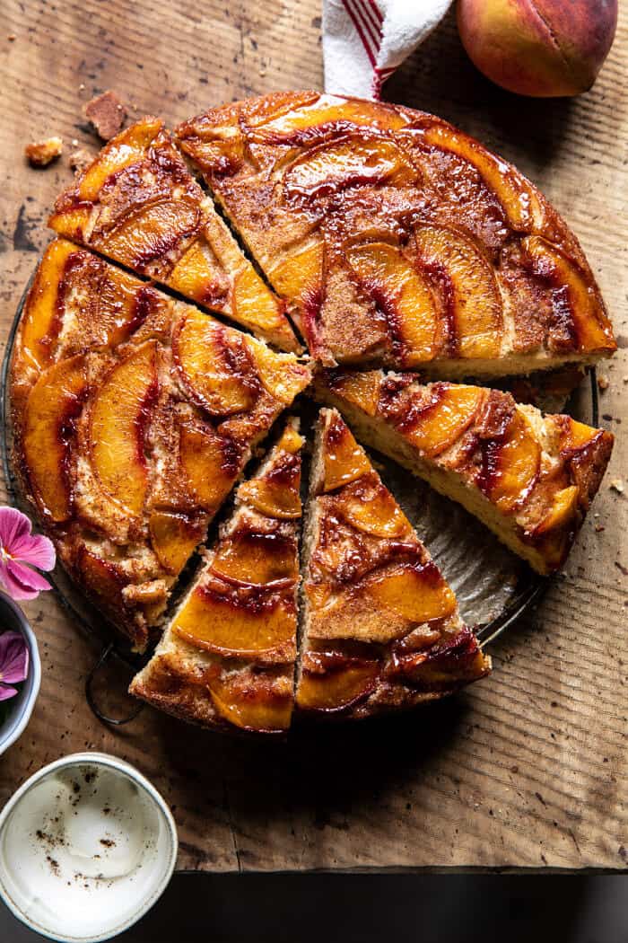 overhead photo of Skillet Cinnamon Sugar Peach Upside Down Cake with slices of cake cut