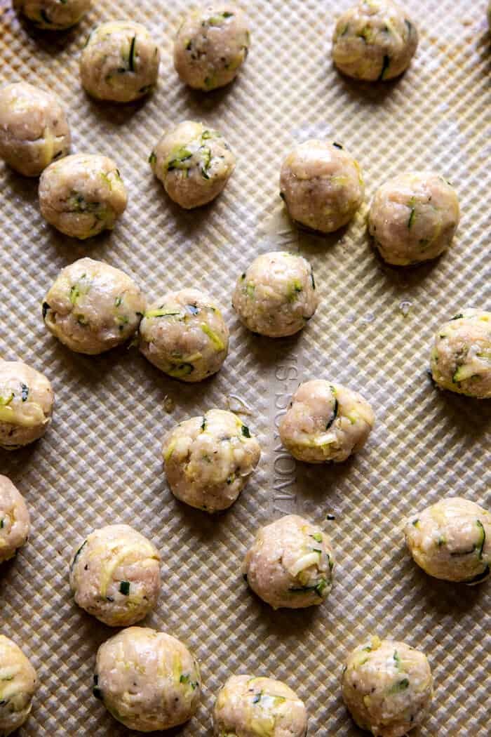 overhead photo of Zucchini Parmesan Chicken Meatballs on baking sheet before baking