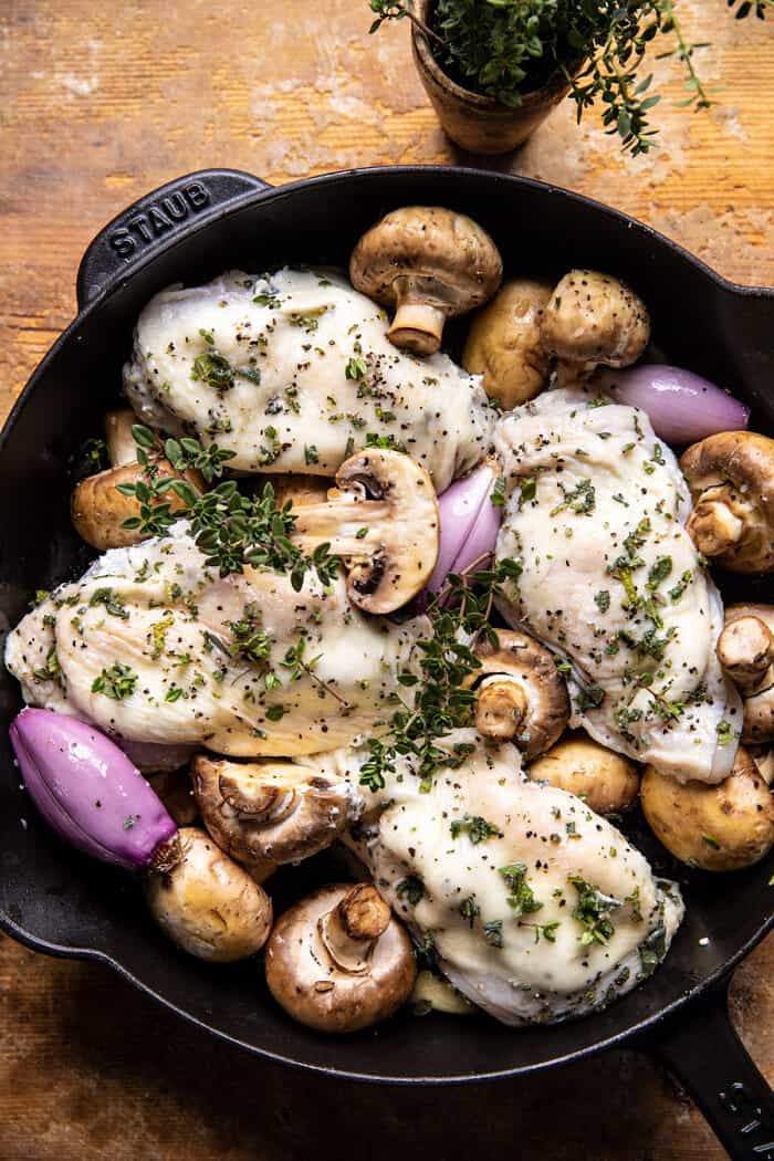 prep photo of Herbed Ricotta Stuffed Chicken and mushrooms in pan before roasting