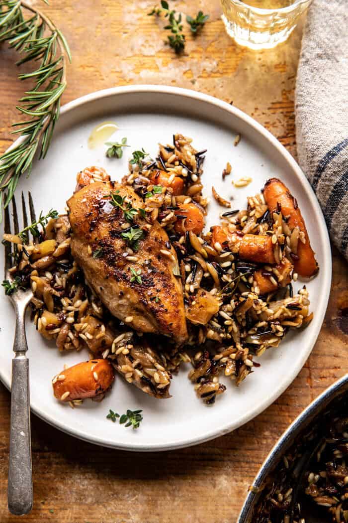 over head photo of One Pot Lemon Rosemary Dijon Chicken and Butter Toasted Rice Pilaf on dinner plate with fork