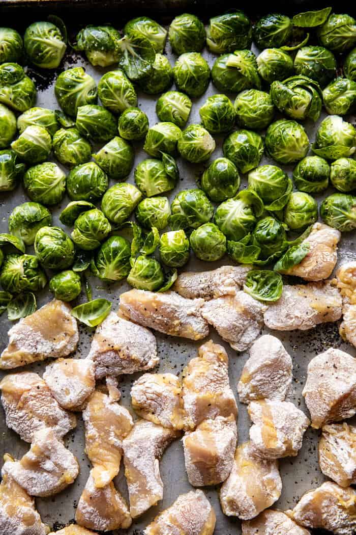 overhead prep photo of Sheet Pan Sticky Ginger Sesame Chicken and Crispy Brussels Sprouts before baking
