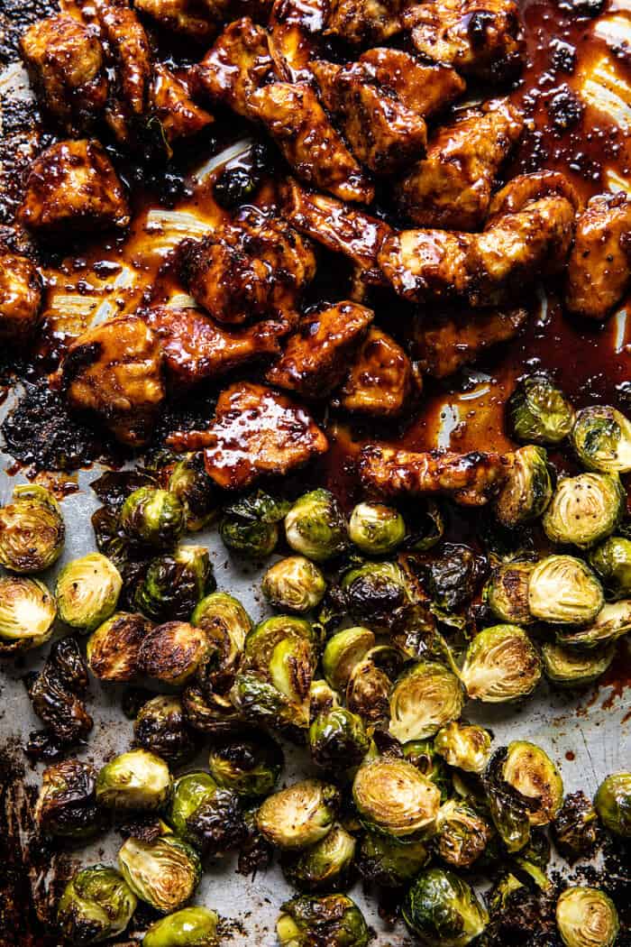 overhead prep photo of Sheet Pan Sticky Ginger Sesame Chicken and Crispy Brussels Sprouts after baking on baking sheet