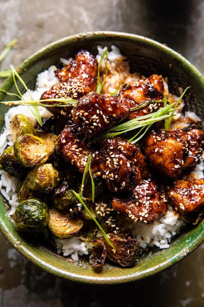 overhead close up photo of Sheet Pan Sticky Ginger Sesame Chicken and Crispy Brussels Sprouts