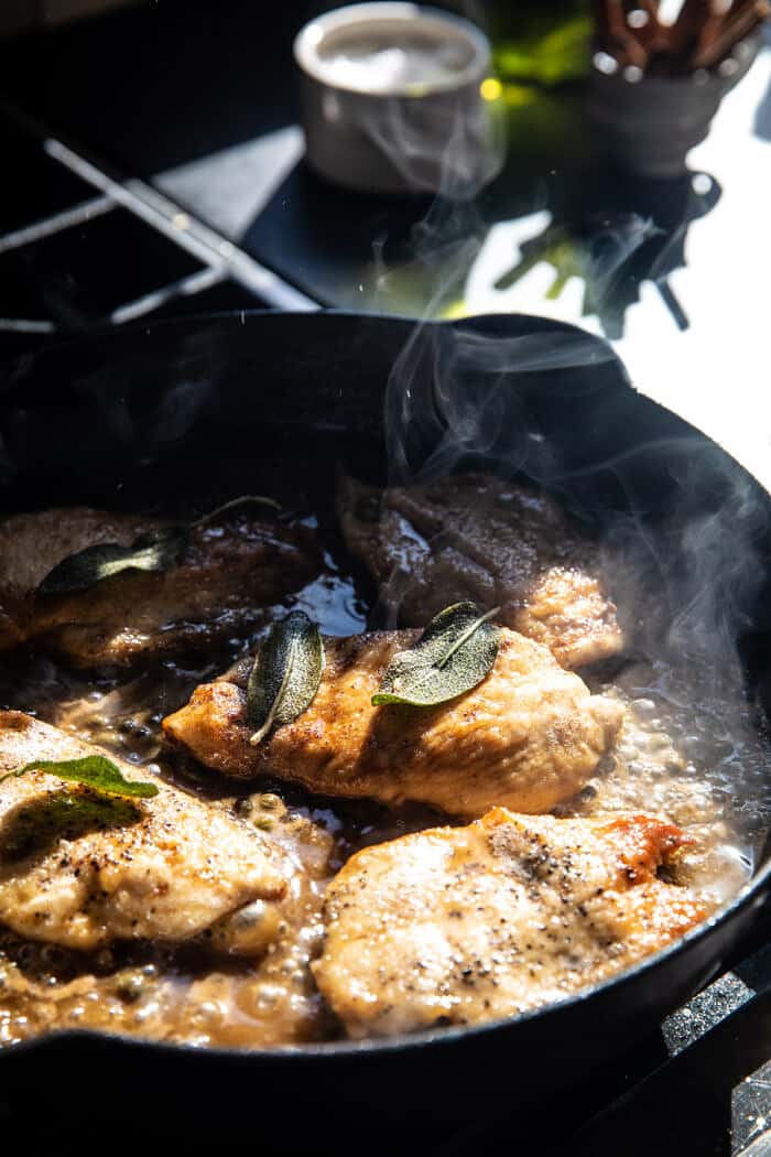 photo of Browned Sage Butter Chicken Piccata cooking on the stove in skillet