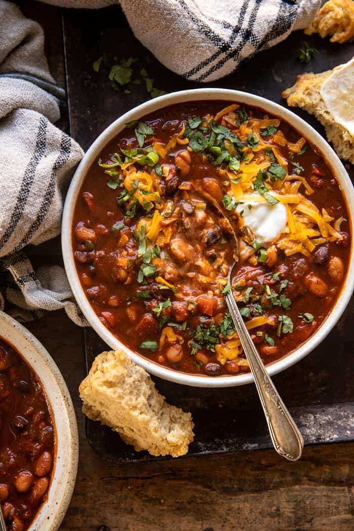 overhead photo of Healthy Slow Cooker Chipotle Bean Chili with spoon in bowl 