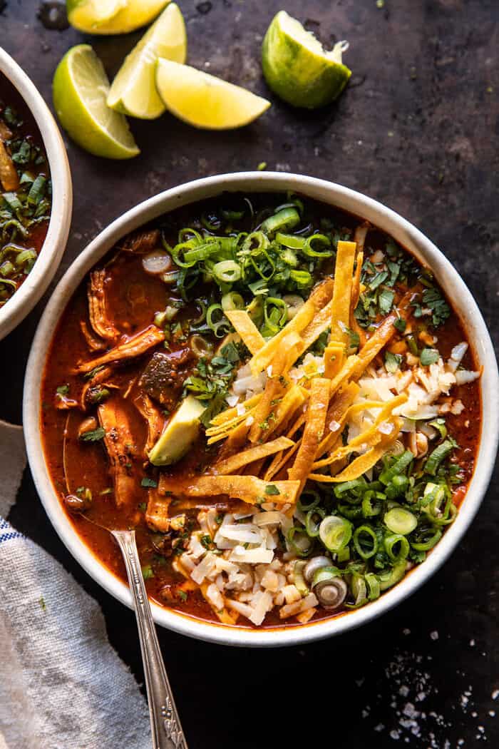 overhead photo of Slow Cooker Chipotle Chicken Tortilla Soup with Salty Lime Chips with spoon in bowl 