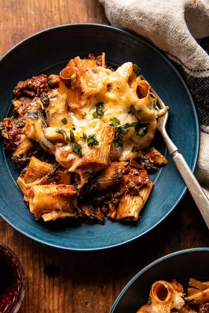 photo of One Pan 4 Cheese Sun-Dried Tomato and Spinach Pasta Bake in serving bowl with fork 