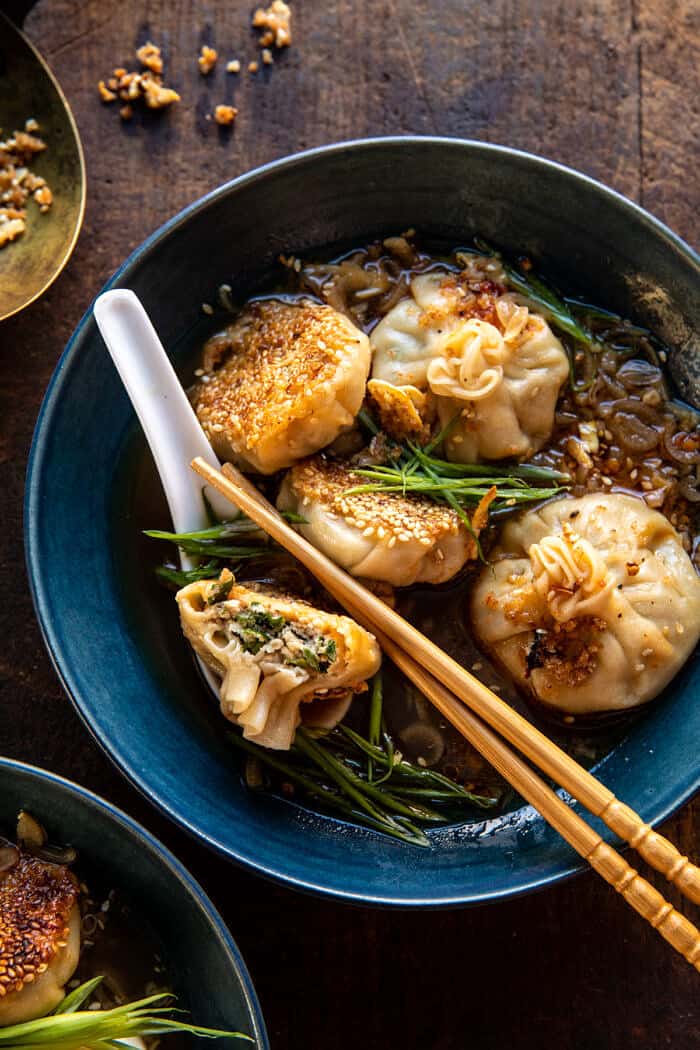 overhead close up photo of Sesame Chicken Dumplings in Spicy Broth with Garlic Crisps 