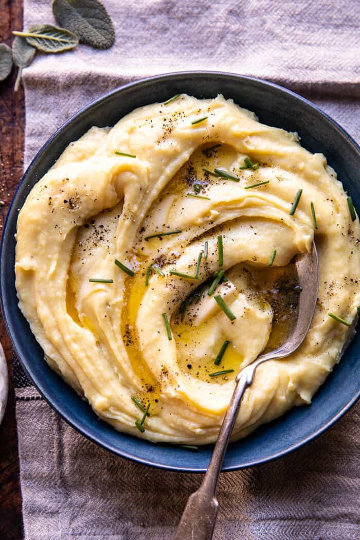 overhead photo of Slow Cooker Cheesy Garlic Herb Mashed Potatoes in serving bowl 