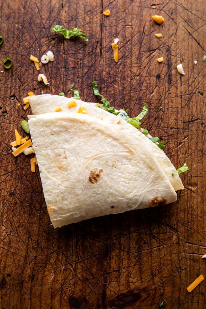 Folded Crispy Buffalo Chicken Wraps | halfbakedharvest.com prep photo of folding the wraps