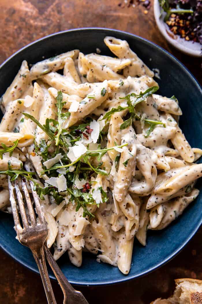 overhead close up photo of One Pot Creamy Penne Alfredo with Spicy Arugula